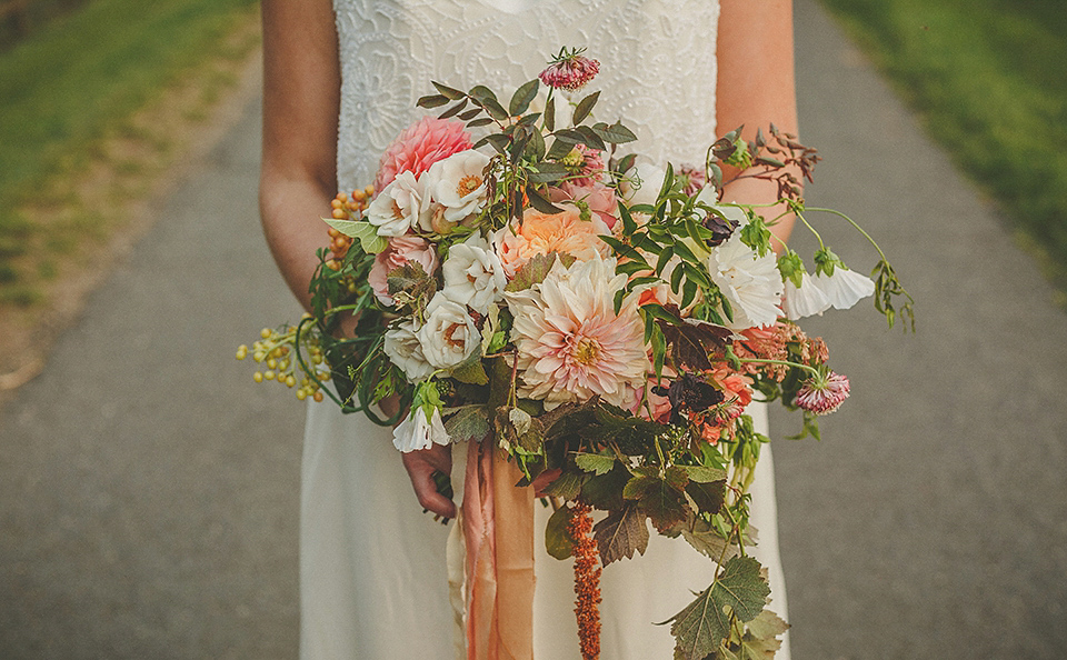 The bride wears an elegant Stephanie Allin gown for her wedding at Childerley in Cambridge. Photography by Howell Jones.