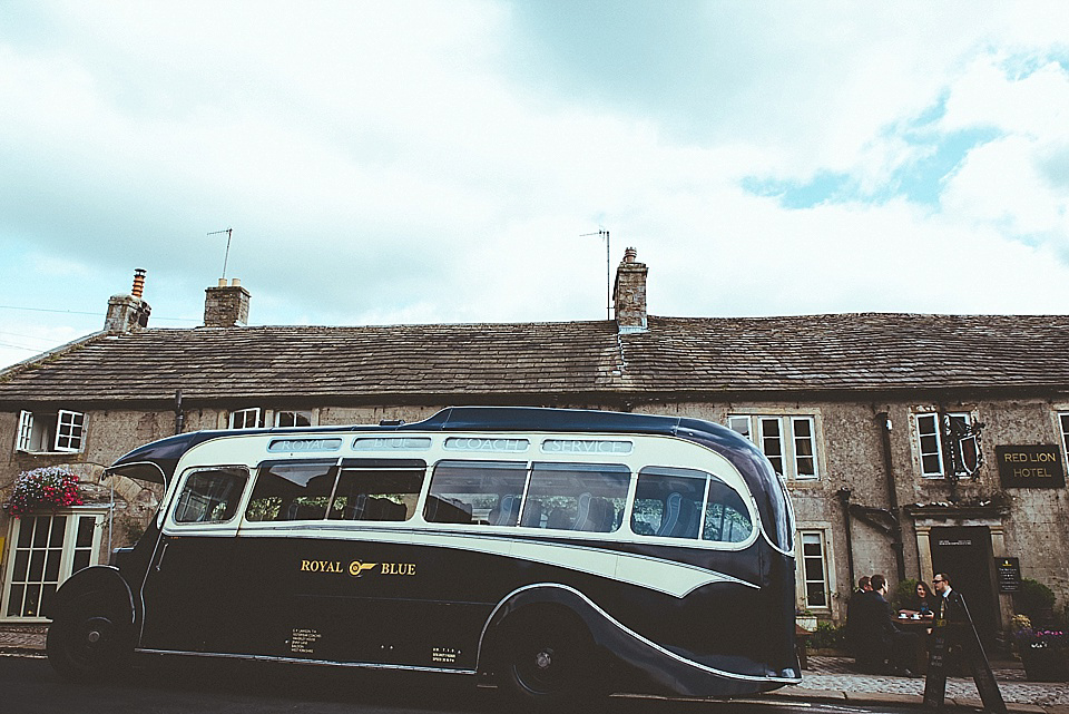 The bride wears a 1950's inspired belted gown by Loulou bridal for her vintage style wedding in North Yorkshire. Photography by Ryan of Shutter Go Click.