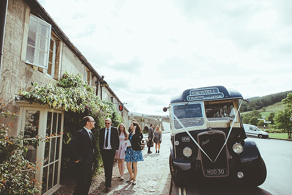 The bride wears a 1950's inspired belted gown by Loulou bridal for her vintage style wedding in North Yorkshire. Photography by Ryan of Shutter Go Click.