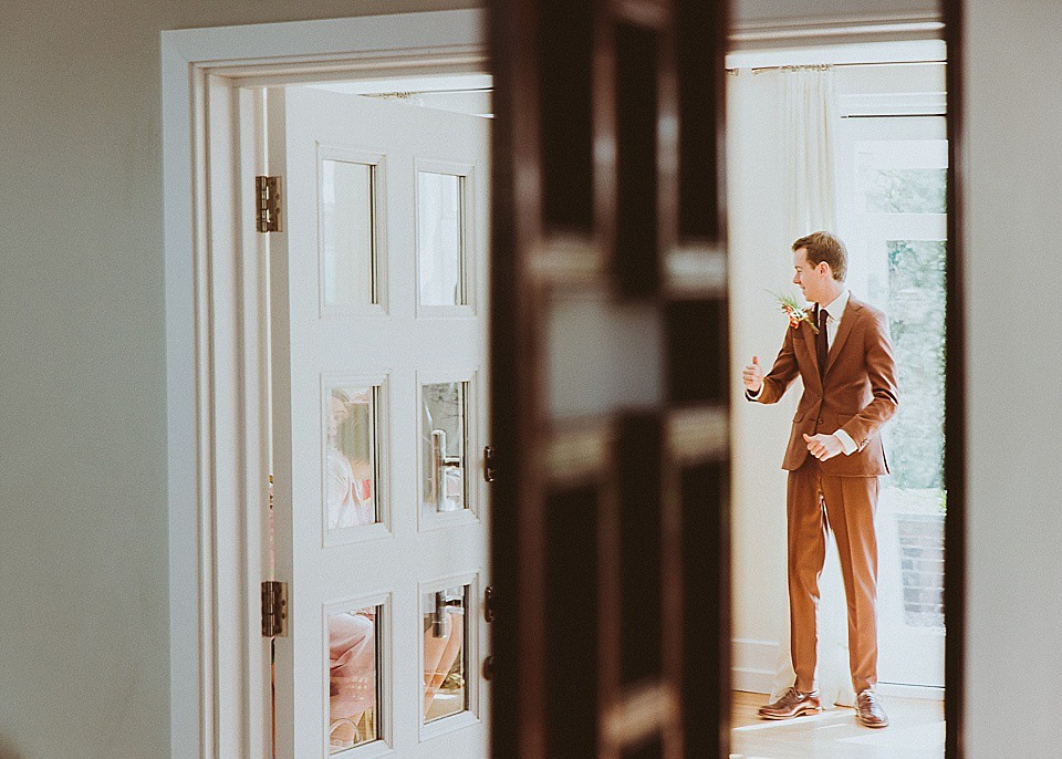 The bride wears a 1950's inspired belted gown by Loulou bridal for her vintage style wedding in North Yorkshire. Photography by Ryan of Shutter Go Click.