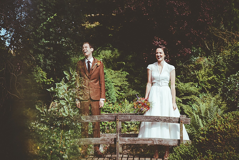 The bride wears a 1950's inspired belted gown by Loulou bridal for her vintage style wedding in North Yorkshire. Photography by Ryan of Shutter Go Click.