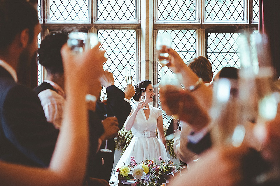 The bride wears a 1950's inspired belted gown by Loulou bridal for her vintage style wedding in North Yorkshire. Photography by Ryan of Shutter Go Click.