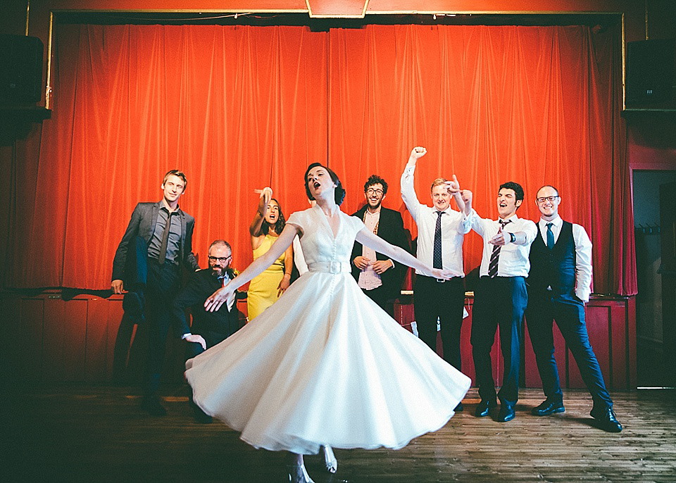 The bride wears a 1950's inspired belted gown by Loulou bridal for her vintage style wedding in North Yorkshire. Photography by Ryan of Shutter Go Click.