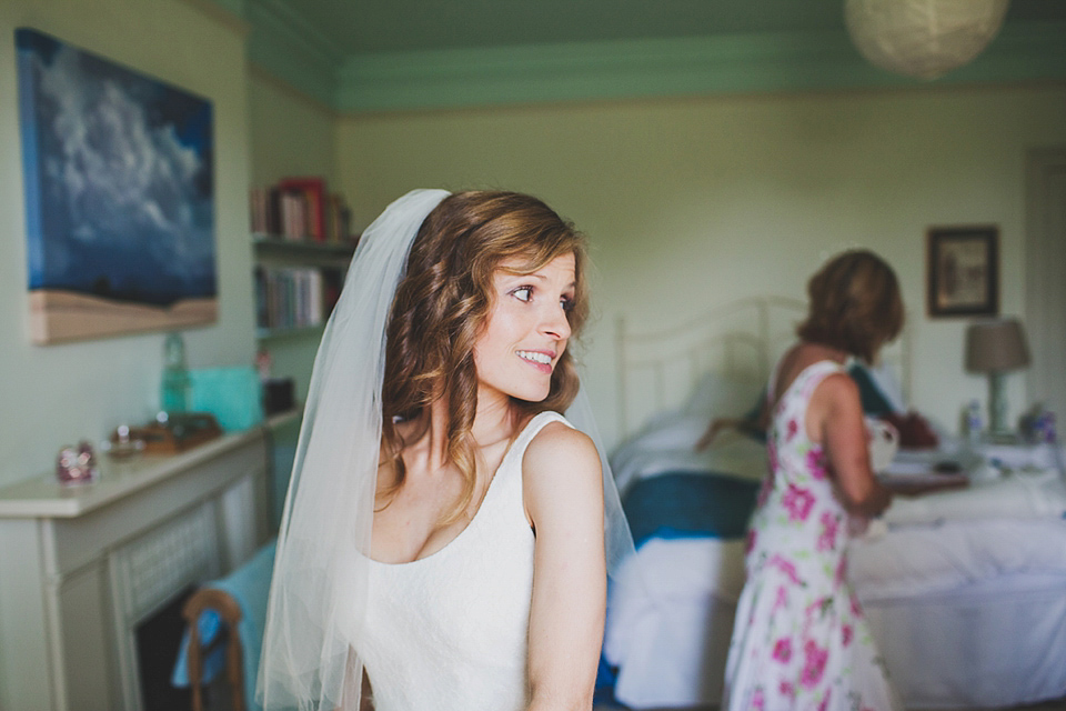 Wildflowers, a meadow, and and elegant Jesus Peiro gown for a handmade summer fete and festival inspired wedding. Photography by Simon Fazackarley.