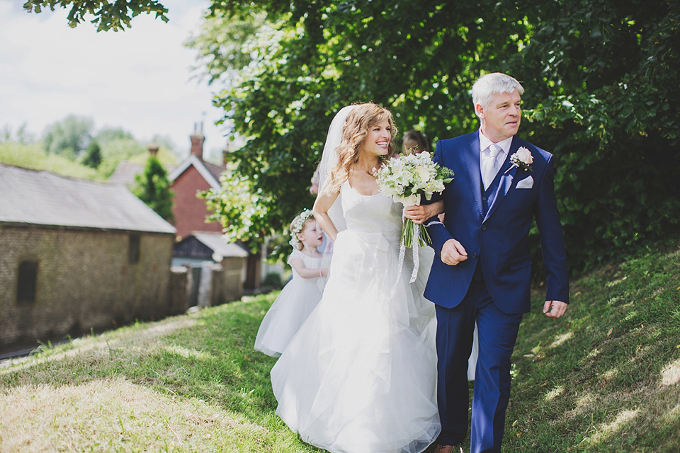 Wildflowers, a meadow, and and elegant Jesus Peiro gown for a handmade summer fete and festival inspired wedding. Photography by Simon Fazackarley.