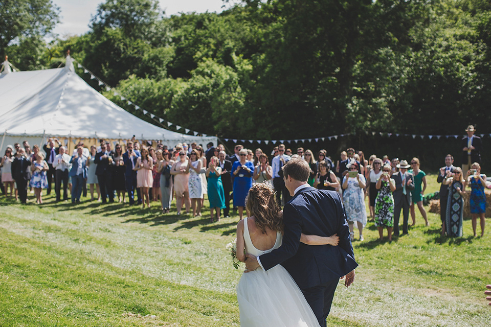 Wildflowers, a meadow, and and elegant Jesus Peiro gown for a handmade summer fete and festival inspired wedding. Photography by Simon Fazackarley.