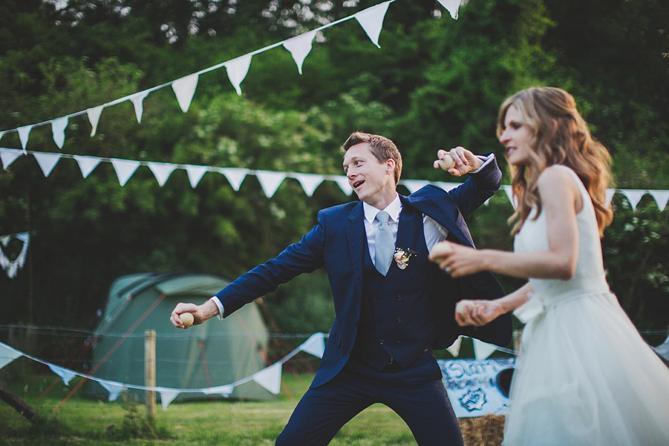 Wildflowers, a meadow, and and elegant Jesus Peiro gown for a handmade summer fete and festival inspired wedding. Photography by Simon Fazackarley.