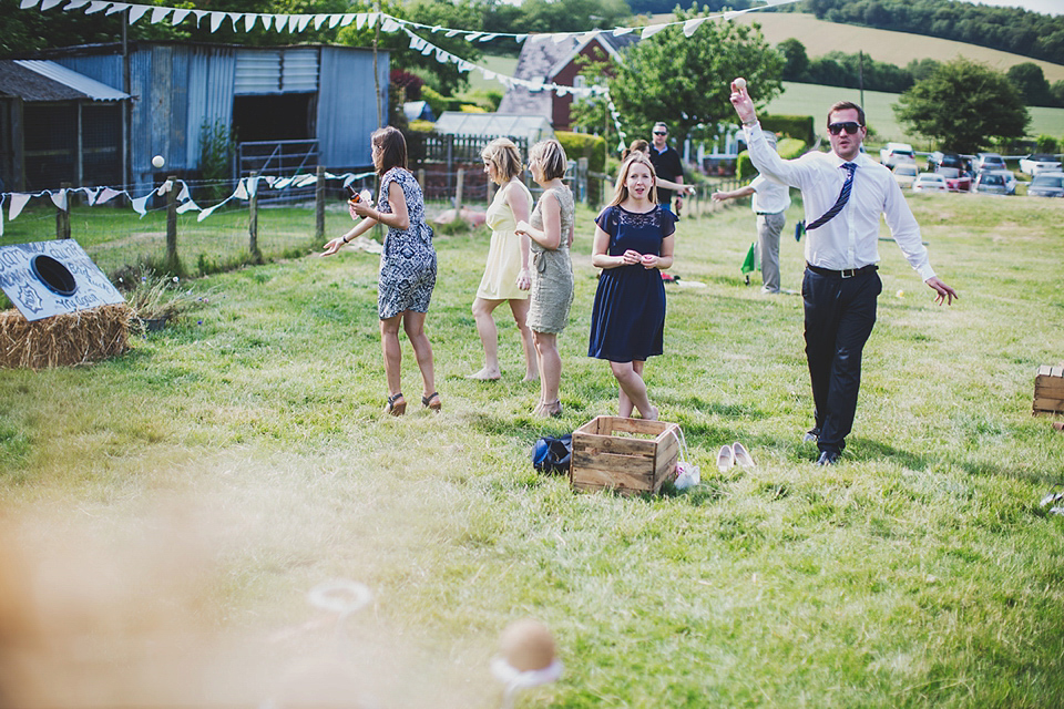 Wildflowers, a meadow, and and elegant Jesus Peiro gown for a handmade summer fete and festival inspired wedding. Photography by Simon Fazackarley.