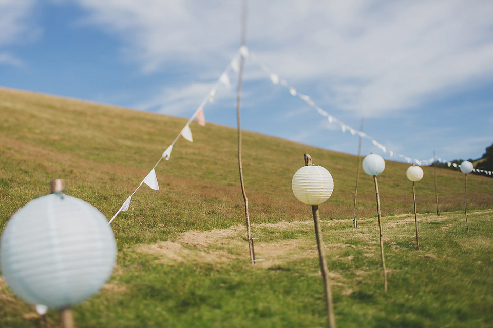 Wildflowers, a meadow, and and elegant Jesus Peiro gown for a handmade summer fete and festival inspired wedding. Photography by Simon Fazackarley.