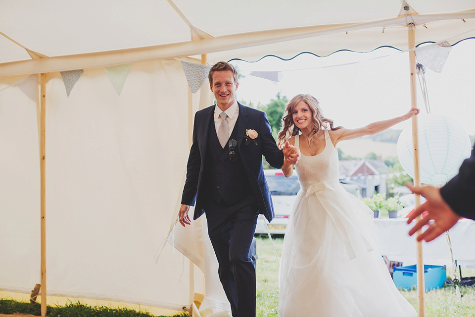 Wildflowers, a meadow, and and elegant Jesus Peiro gown for a handmade summer fete and festival inspired wedding. Photography by Simon Fazackarley.