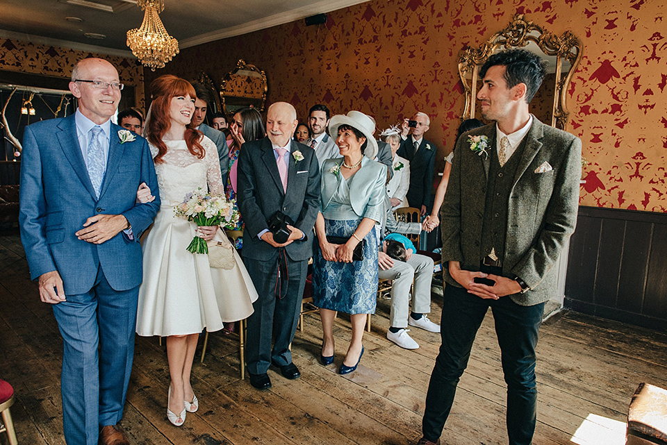 Bride Amy wears a replica 1960s wedding dress, designed by Fur Coat No Knickers of London, for her quirky and kitsch wedding. Photography by Jacqui McSweeney.