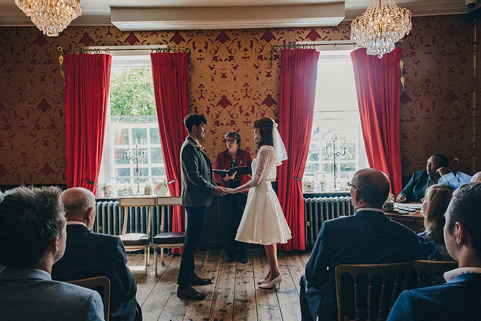 Bride Amy wears a replica 1960s wedding dress, designed by Fur Coat No Knickers of London, for her quirky and kitsch wedding. Photography by Jacqui McSweeney.