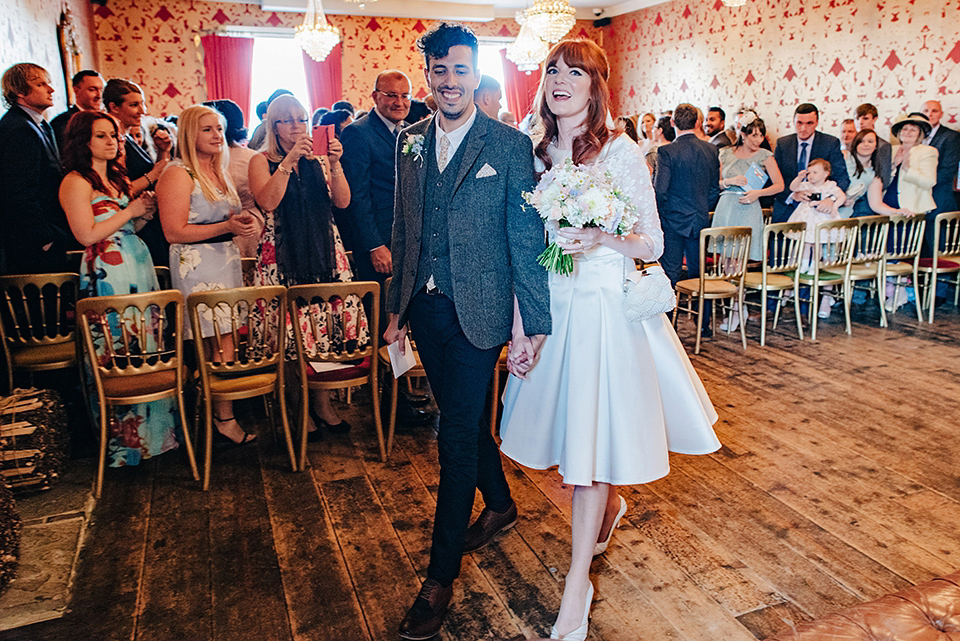 Bride Amy wears a replica 1960s wedding dress, designed by Fur Coat No Knickers of London, for her quirky and kitsch wedding. Photography by Jacqui McSweeney.