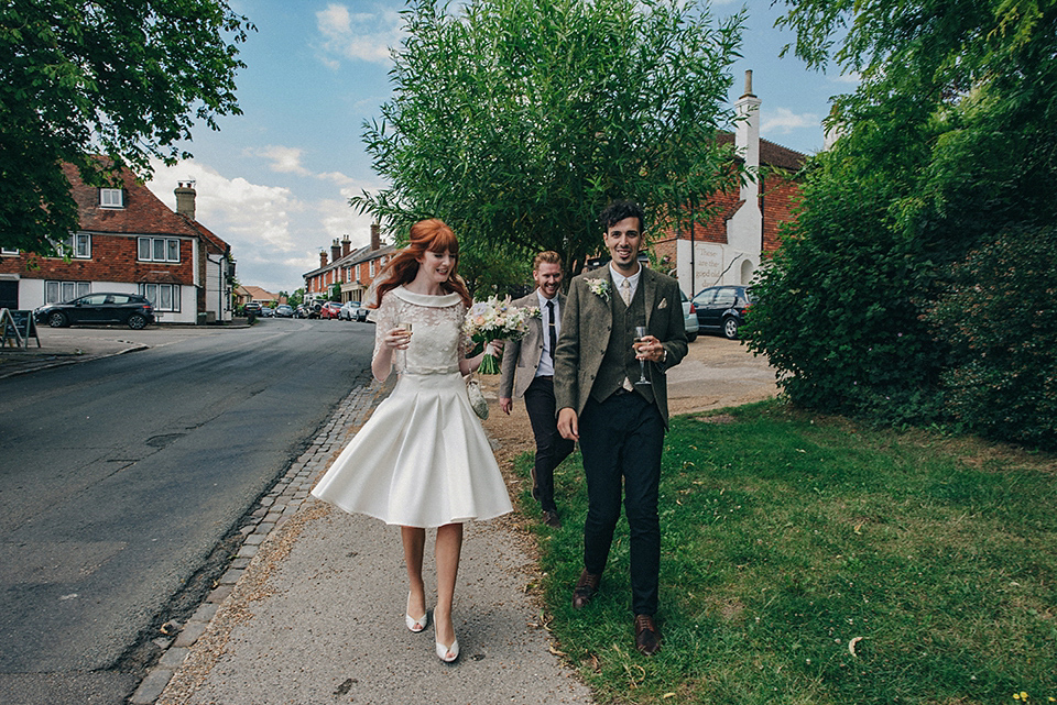 Bride Amy wears a replica 1960s wedding dress, designed by Fur Coat No Knickers of London, for her quirky and kitsch wedding. Photography by Jacqui McSweeney.