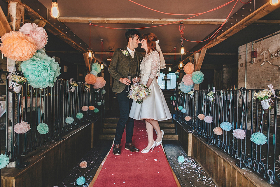 Bride Amy wears a replica 1960s wedding dress, designed by Fur Coat No Knickers of London, for her quirky and kitsch wedding. Photography by Jacqui McSweeney.