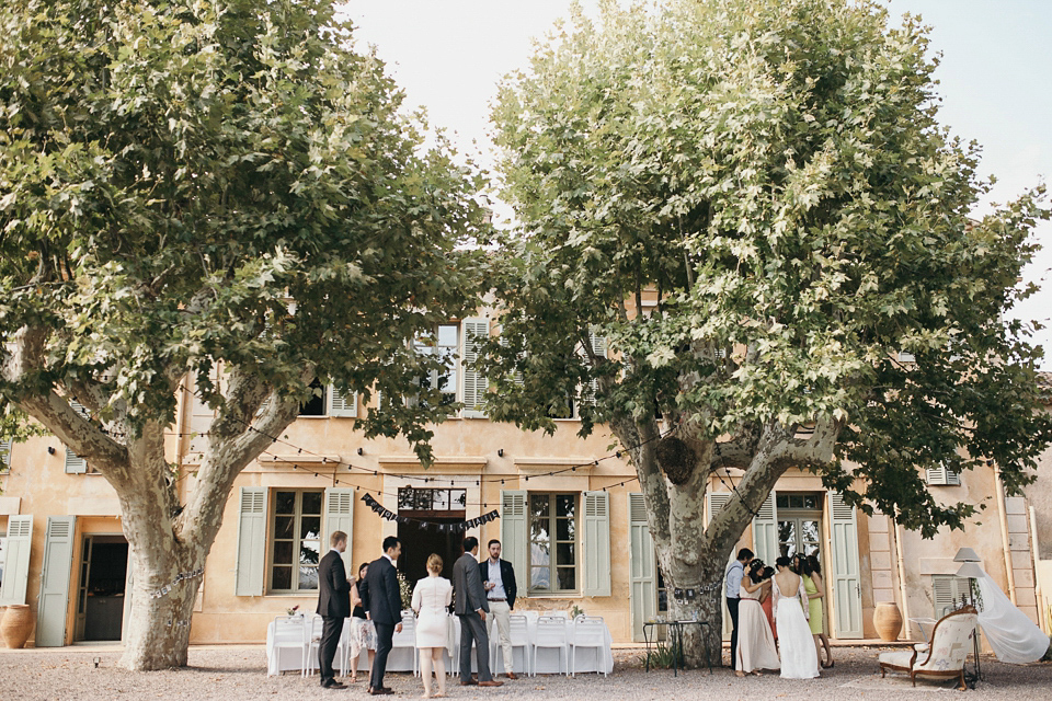 A first look and floral crown for an elegant and intimate chateau wedding in the South of France. Photography by Sabestien Boudot.