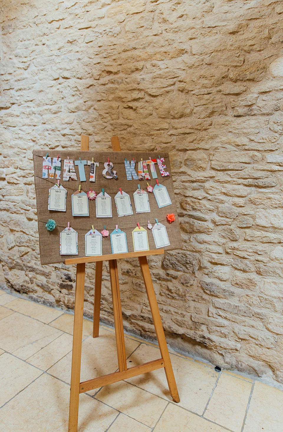 A Charlie Brear gownf for a colourful, flower-filled wedding at Kingscote Barn. Photography by Charlotte Bryer-Ash.