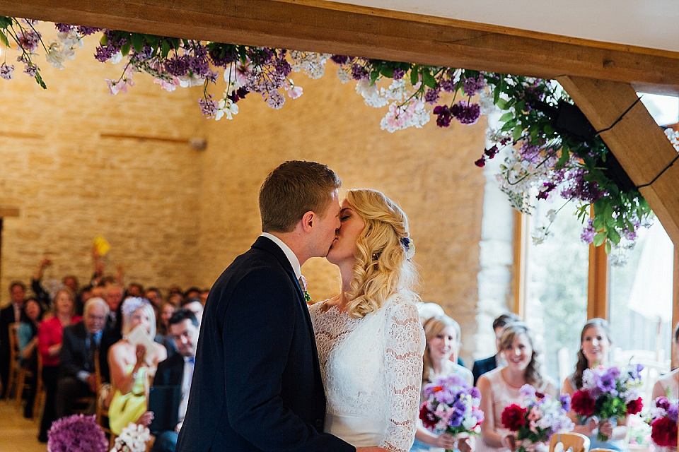 A Charlie Brear gownf for a colourful, flower-filled wedding at Kingscote Barn. Photography by Charlotte Bryer-Ash.