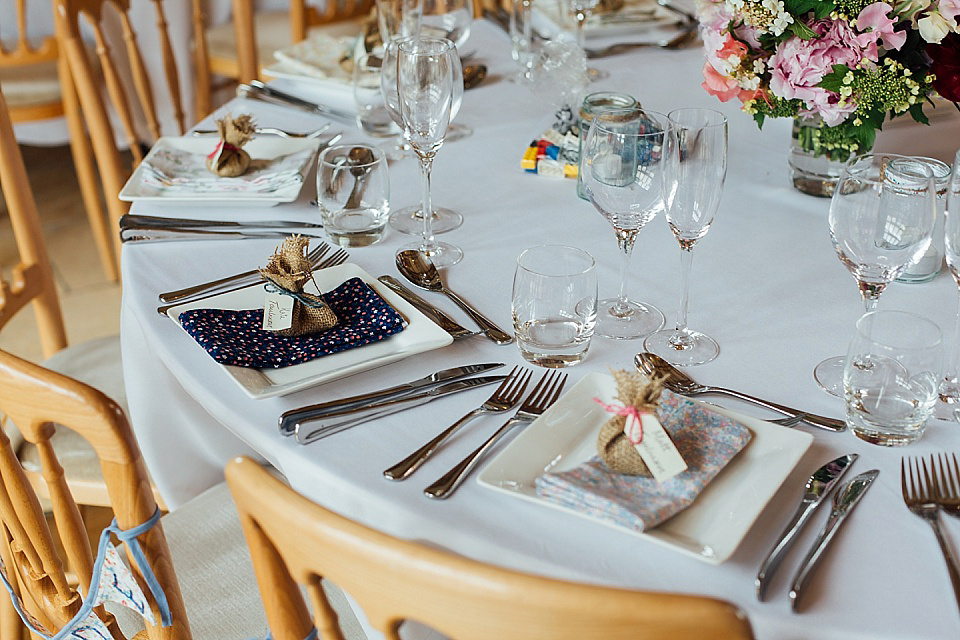 A Charlie Brear gownf for a colourful, flower-filled wedding at Kingscote Barn. Photography by Charlotte Bryer-Ash.