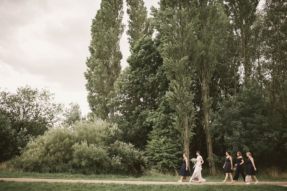 An elegant English countryside barn wedding in Oxfordshire. Photography by Tom Ravenshear. The bride wears a dress by designer Sienna Von Hildemar