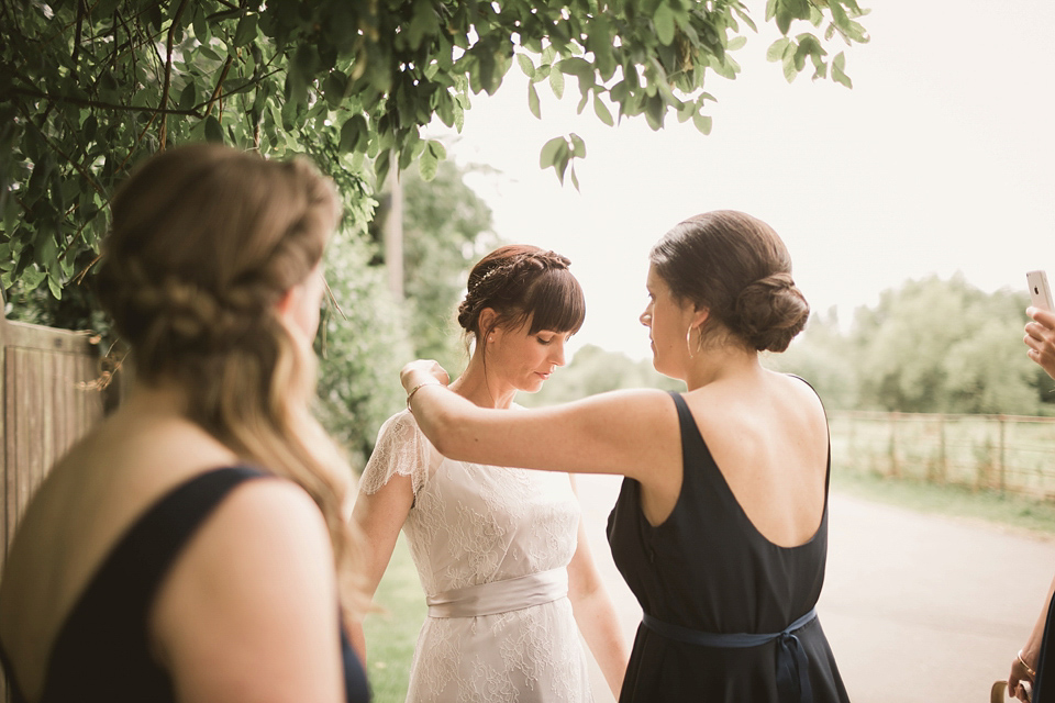 An elegant English countryside barn wedding in Oxfordshire. Photography by Tom Ravenshear. The bride wears a dress by designer Sienna Von Hildemar