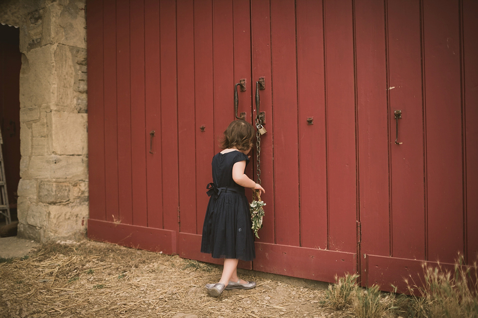 An elegant English countryside barn wedding in Oxfordshire. Photography by Tom Ravenshear. The bride wears a dress by designer Sienna Von Hildemar