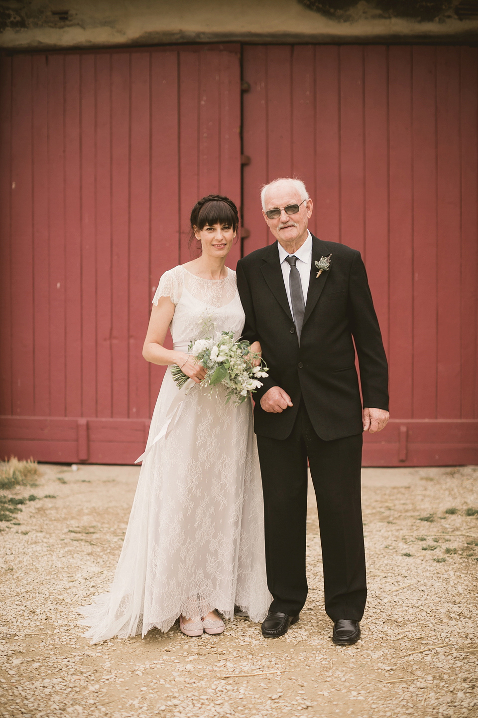 An elegant English countryside barn wedding in Oxfordshire. Photography by Tom Ravenshear. The bride wears a dress by designer Sienna Von Hildemar