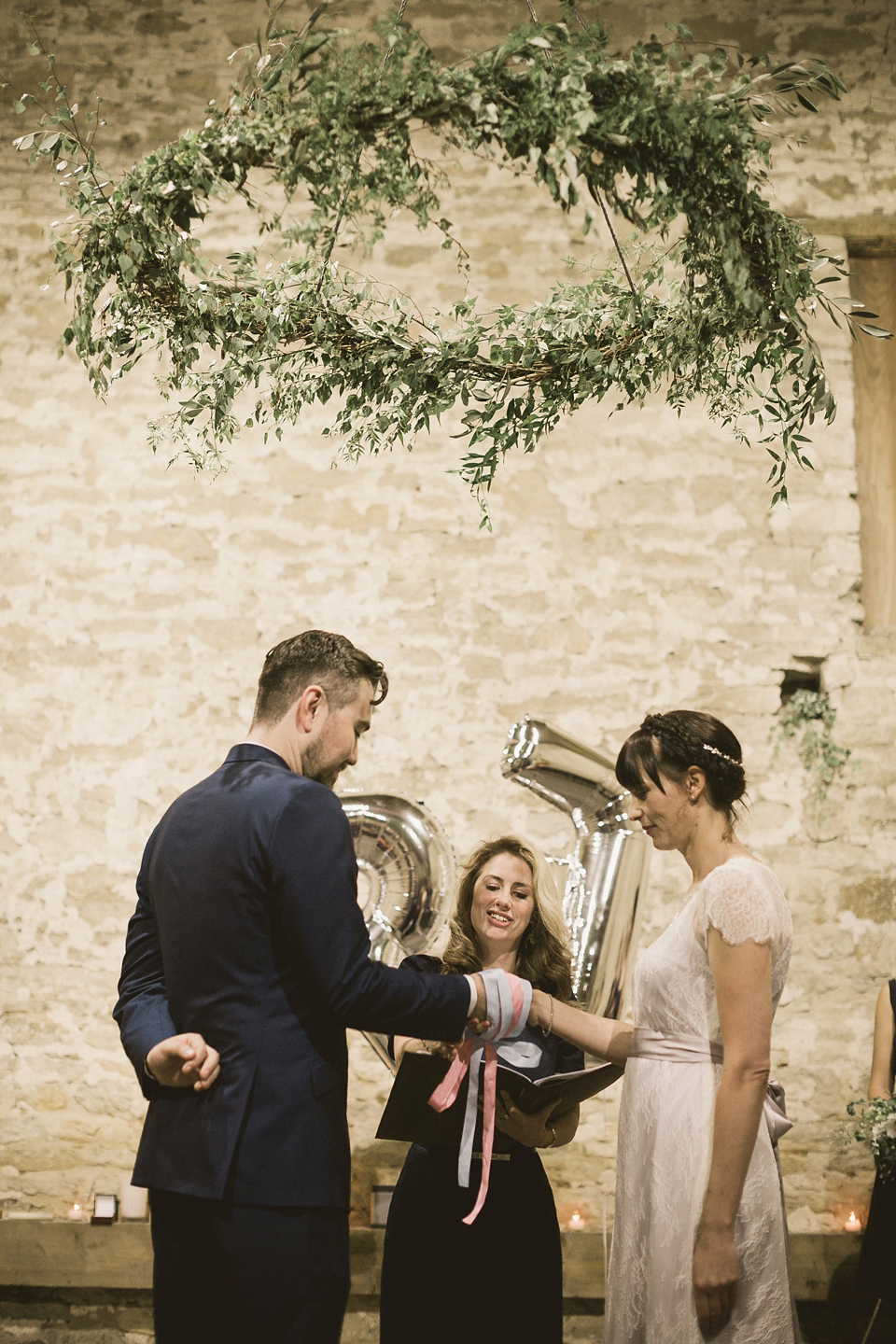 An elegant English countryside barn wedding in Oxfordshire. Photography by Tom Ravenshear. The bride wears a dress by designer Sienna Von Hildemar