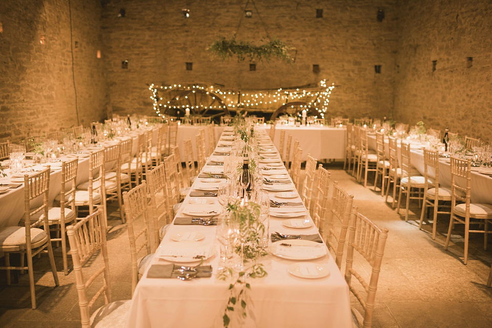 An elegant English countryside barn wedding in Oxfordshire. Photography by Tom Ravenshear. The bride wears a dress by designer Sienna Von Hildemar