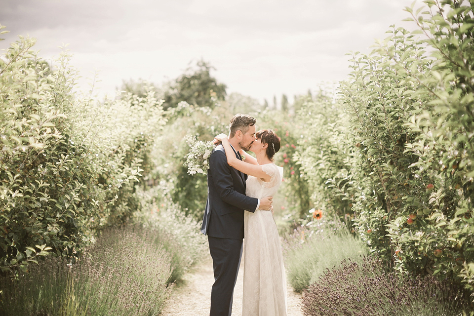 An elegant English countryside barn wedding in Oxfordshire. Photography by Tom Ravenshear. The bride wears a dress by designer Sienna Von Hildemar