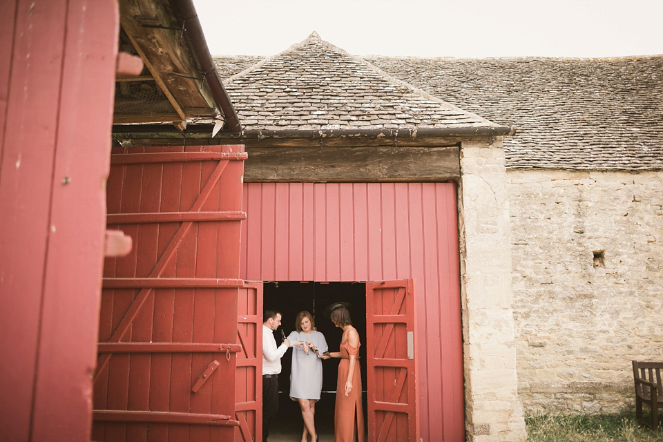 An elegant English countryside barn wedding in Oxfordshire. Photography by Tom Ravenshear. The bride wears a dress by designer Sienna Von Hildemar