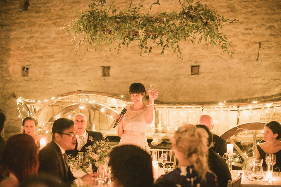 An elegant English countryside barn wedding in Oxfordshire. Photography by Tom Ravenshear. The bride wears a dress by designer Sienna Von Hildemar