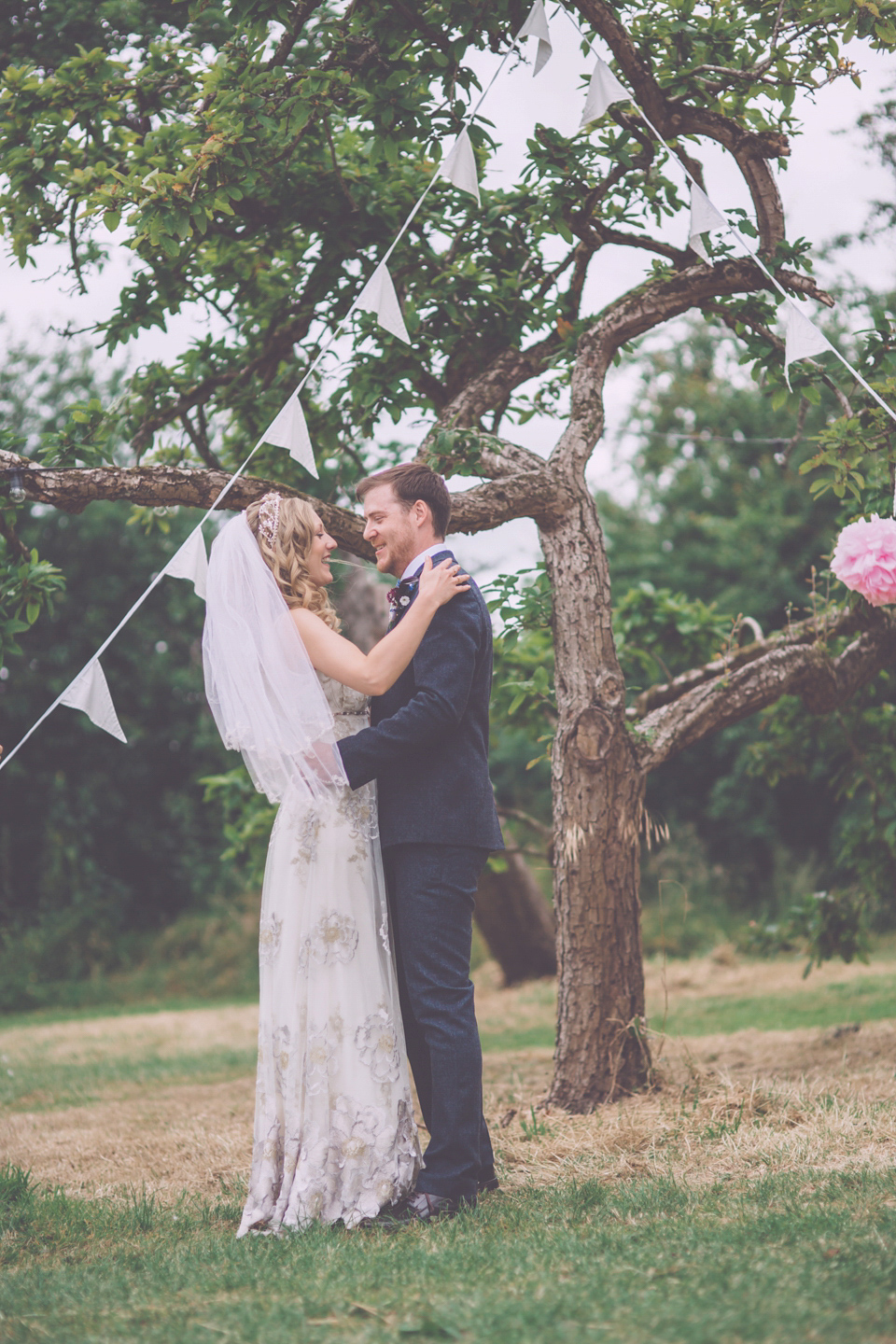 Bride Jo wears a Claire Pettibone gown and vintage tiara for her colourful, homespun and humanist wedding celebration. Photography by Naomi Jane Photography.