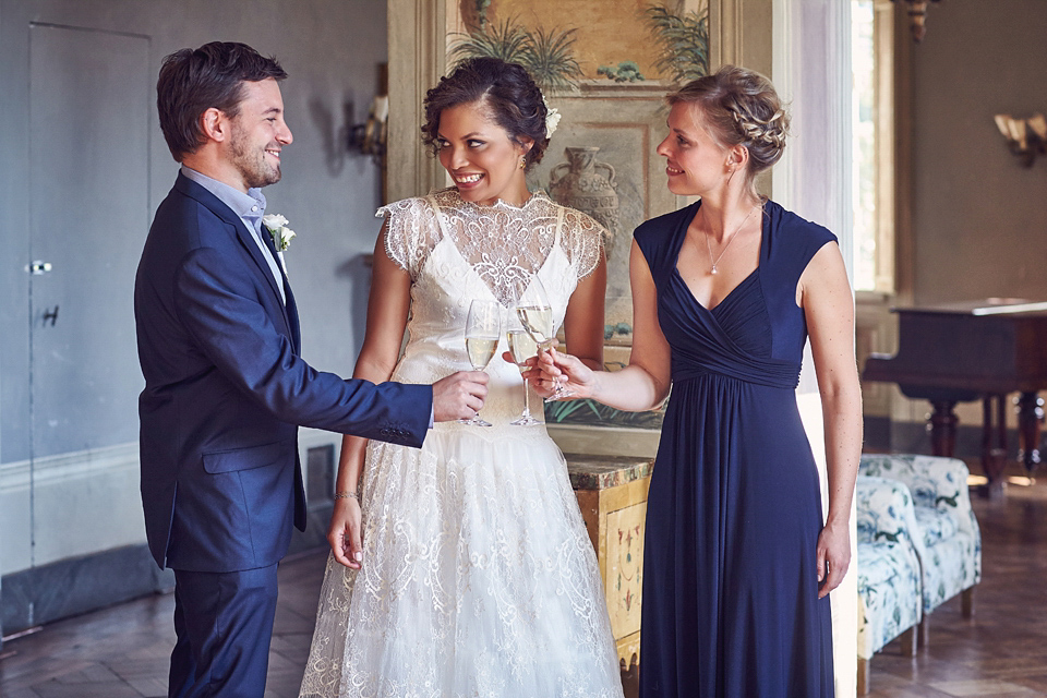 A short, lace, Rembo Styling wedding dress and shades of navy blue for a garden blessing in Tuscany. Photography by Jules Bower.