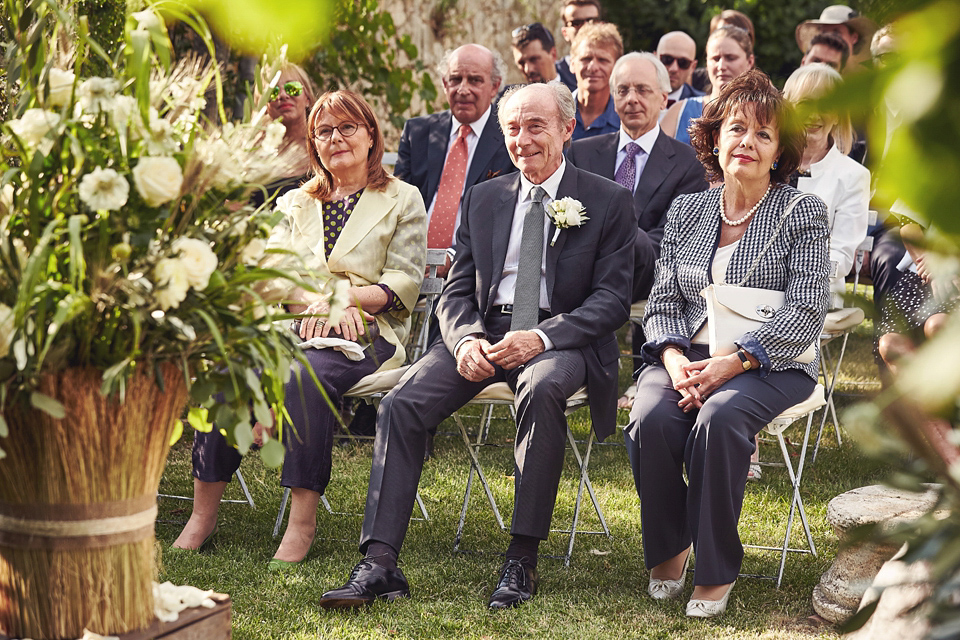 A short, lace, Rembo Styling wedding dress and shades of navy blue for a garden blessing in Tuscany. Photography by Jules Bower.