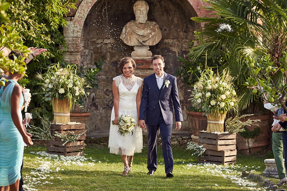 A short, lace, Rembo Styling wedding dress and shades of navy blue for a garden blessing in Tuscany. Photography by Jules Bower.