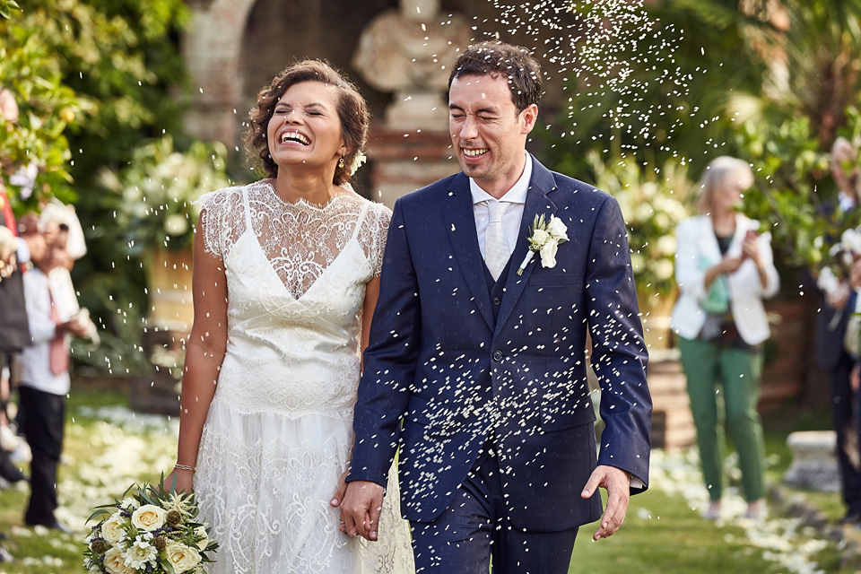 A short, lace, Rembo Styling wedding dress and shades of navy blue for a garden blessing in Tuscany. Photography by Jules Bower.