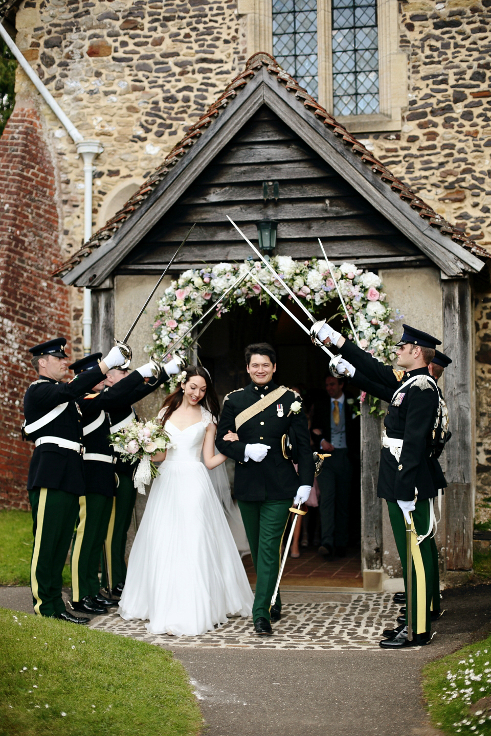 Bride Chloe wore a Suzanne Neville gown which she purchased from Miss Bush Bridal in Surrey, for her military style wedding in the English countryside. Photography by Dasha Caffrey.