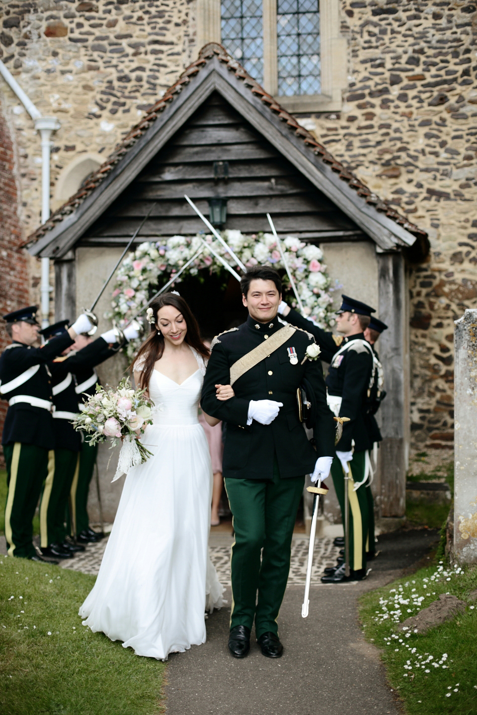 Bride Chloe wore a Suzanne Neville gown which she purchased from Miss Bush Bridal in Surrey, for her military style wedding in the English countryside. Photography by Dasha Caffrey.