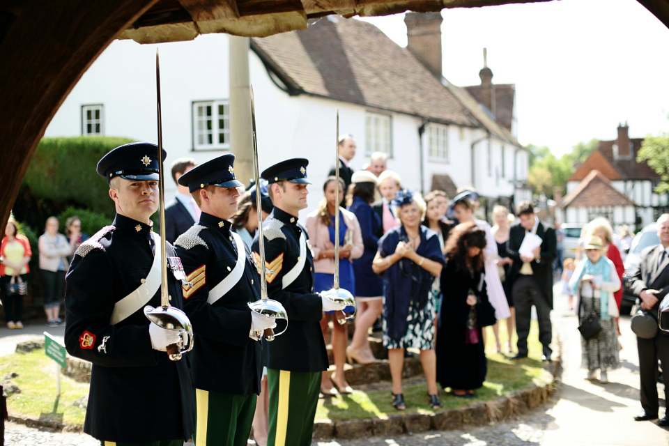 Bride Chloe wore a Suzanne Neville gown which she purchased from Miss Bush Bridal in Surrey, for her military style wedding in the English countryside. Photography by Dasha Caffrey.