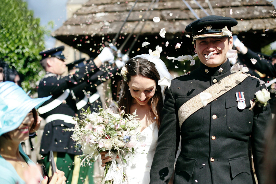 Bride Chloe wore a Suzanne Neville gown which she purchased from Miss Bush Bridal in Surrey, for her military style wedding in the English countryside. Photography by Dasha Caffrey.