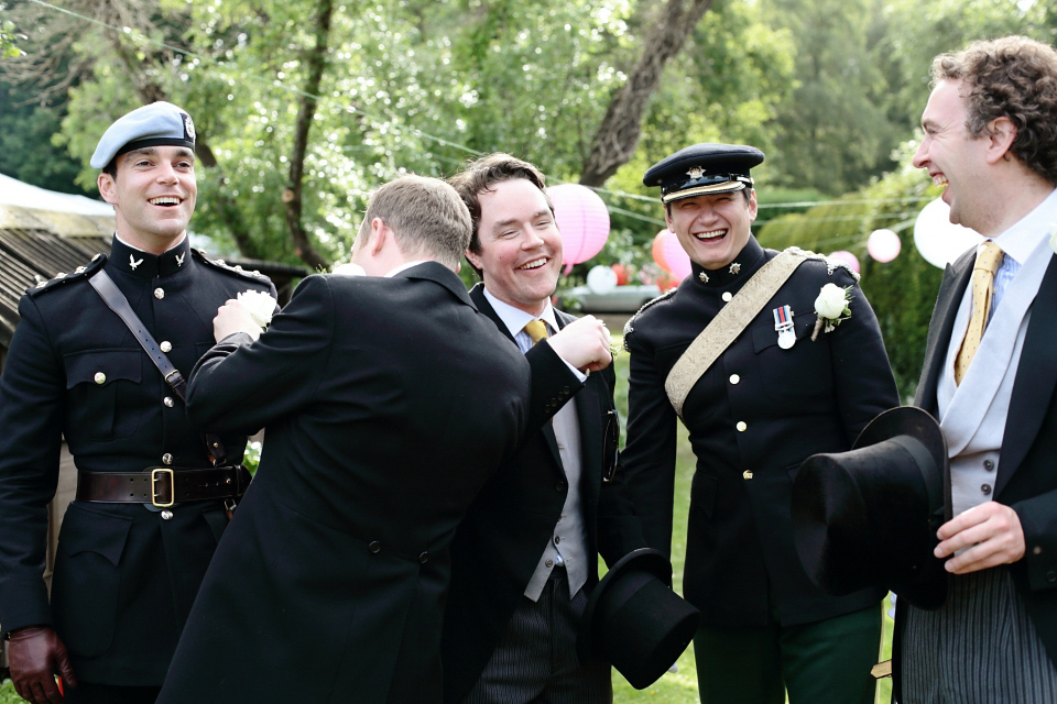 Bride Chloe wore a Suzanne Neville gown which she purchased from Miss Bush Bridal in Surrey, for her military style wedding in the English countryside. Photography by Dasha Caffrey.