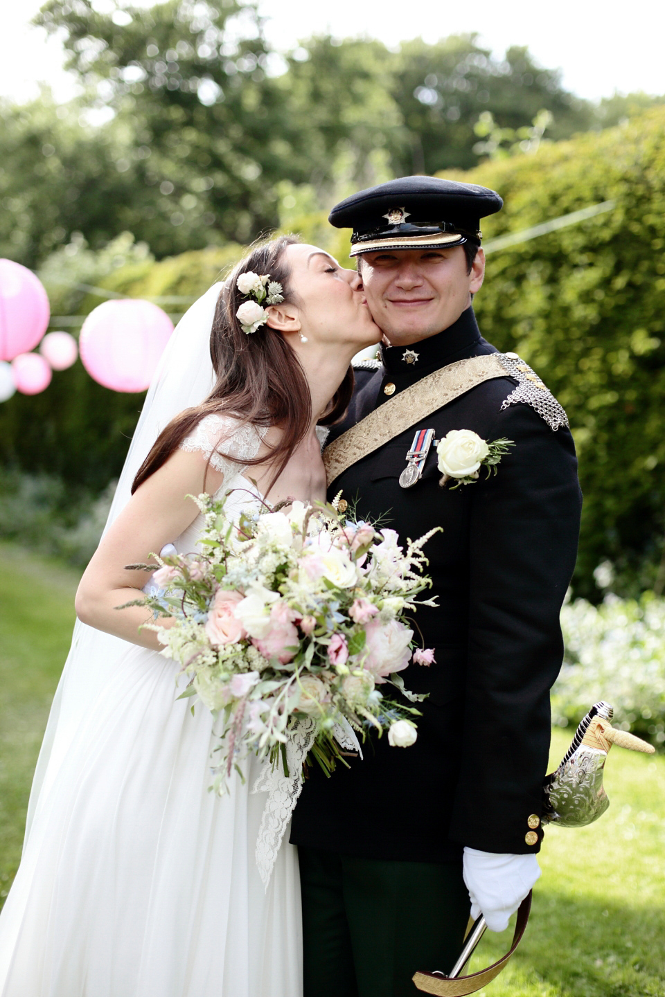 Bride Chloe wore a Suzanne Neville gown which she purchased from Miss Bush Bridal in Surrey, for her military style wedding in the English countryside. Photography by Dasha Caffrey.