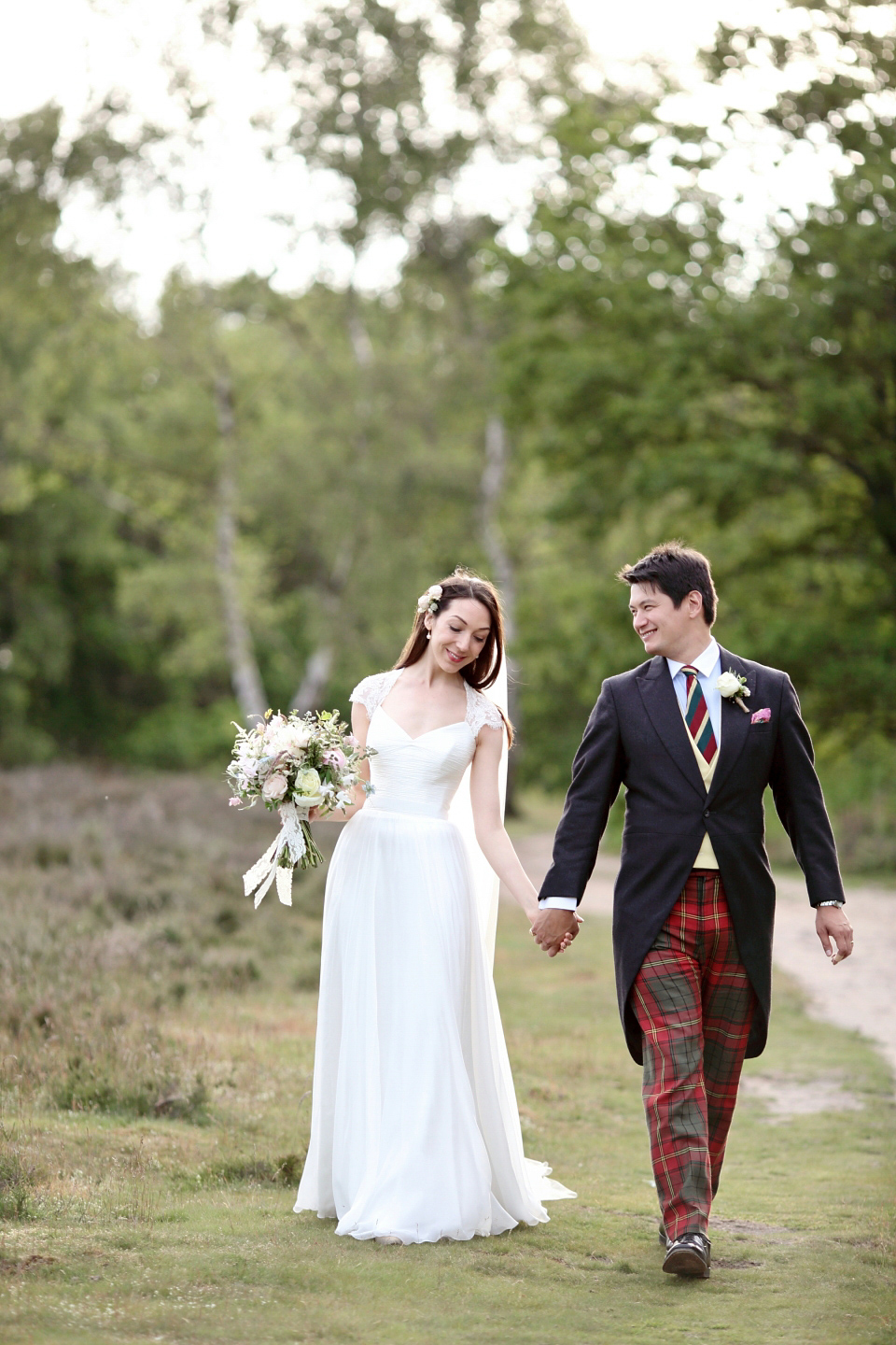 Bride Chloe wore a Suzanne Neville gown which she purchased from Miss Bush Bridal in Surrey, for her military style wedding in the English countryside. Photography by Dasha Caffrey.