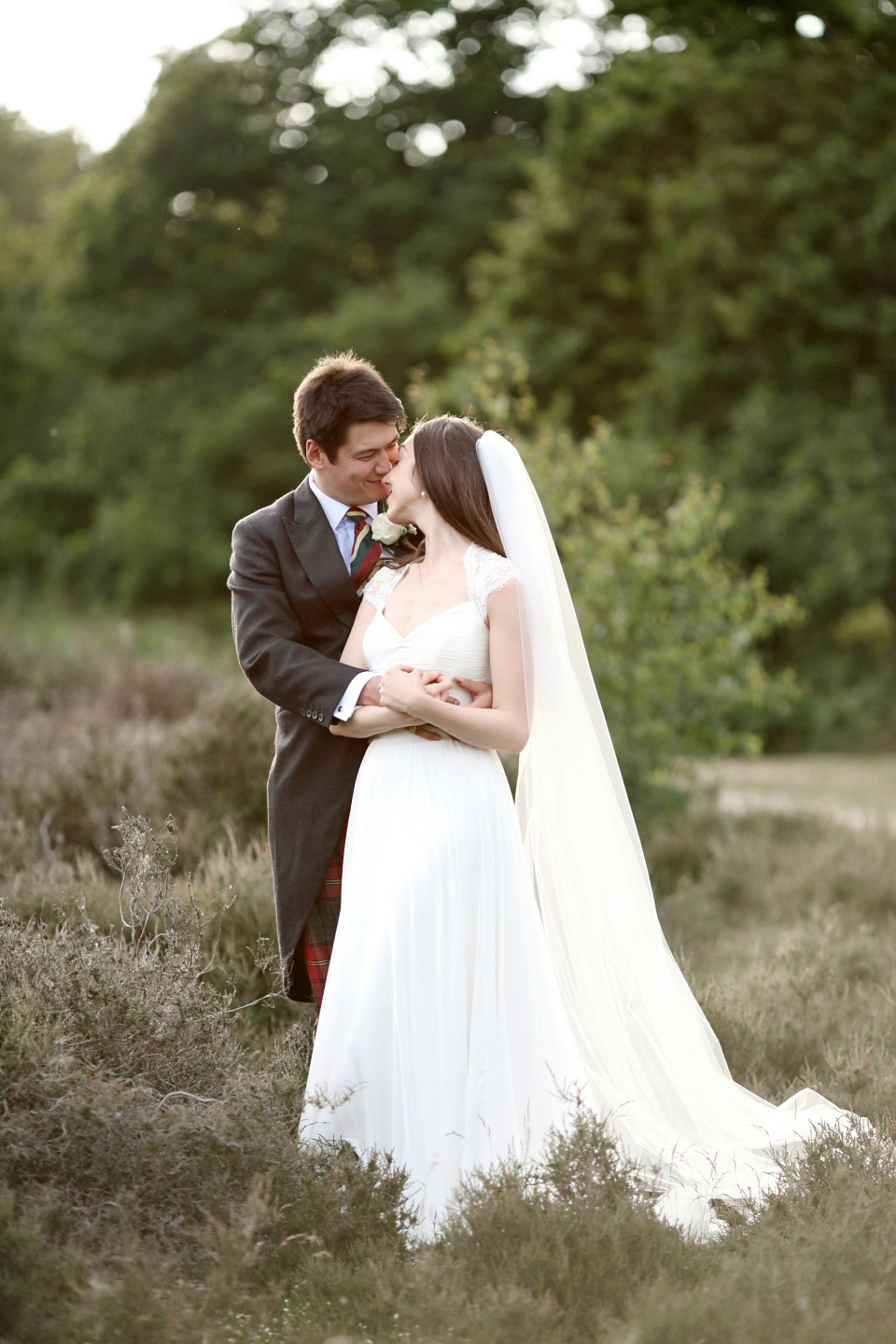 Bride Chloe wore a Suzanne Neville gown which she purchased from Miss Bush Bridal in Surrey, for her military style wedding in the English countryside. Photography by Dasha Caffrey.