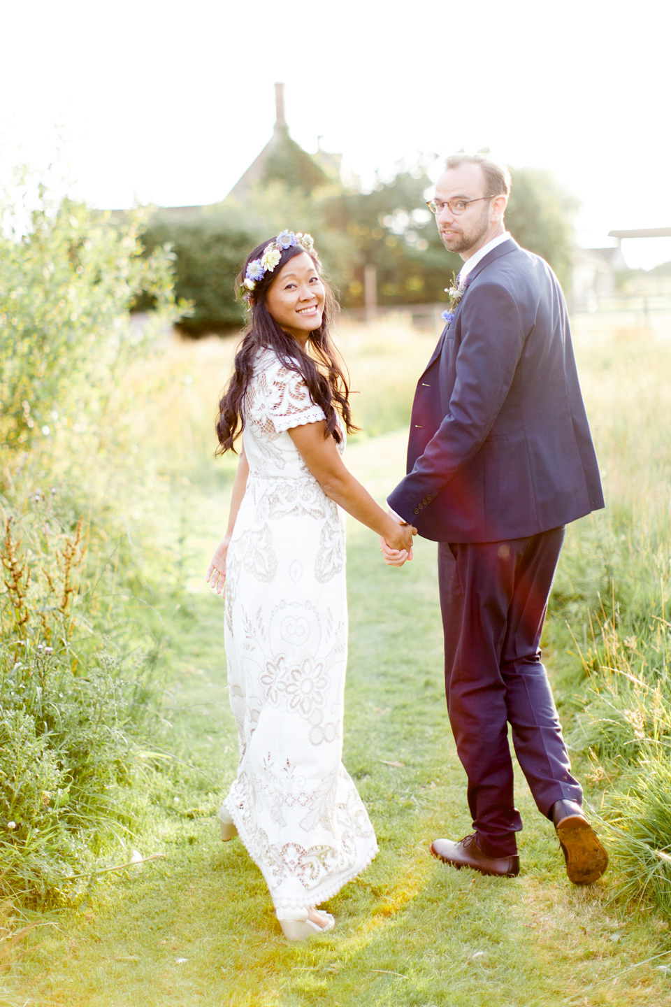 Jenny wore a 'Lost in Paris' gown, created from vintage French lace, for her spiritual and homespun wedding held at Court Farm in Somerset. Photography by Kerry Bartlett