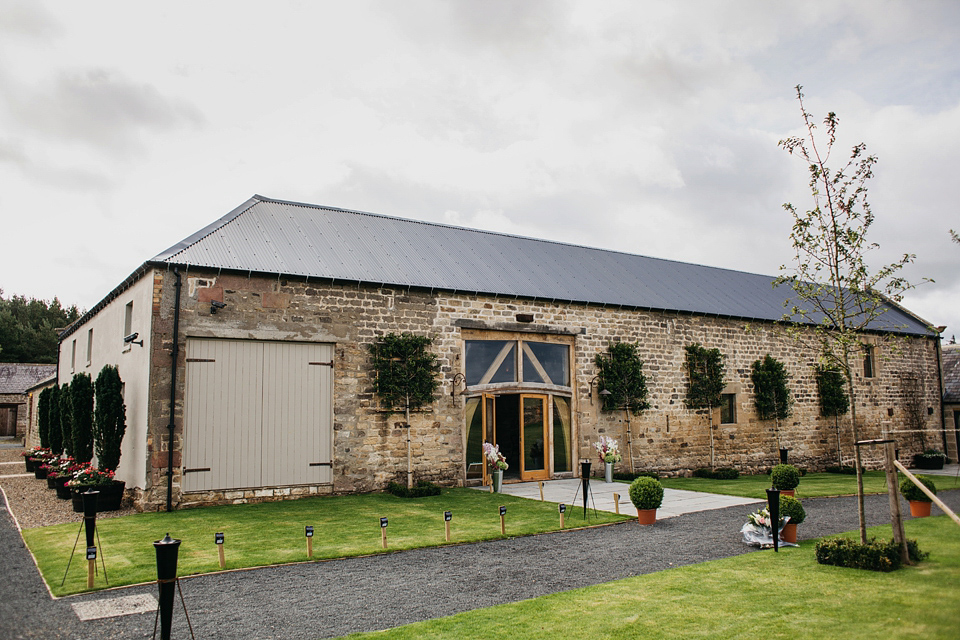 A Suzanne Neville gown and shades fo pink for a colourful wedding at Healey Barn, Northumberland. Photography by John Hope.