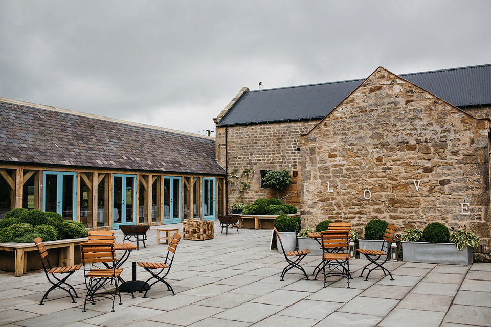 A Suzanne Neville gown and shades fo pink for a colourful wedding at Healey Barn, Northumberland. Photography by John Hope.