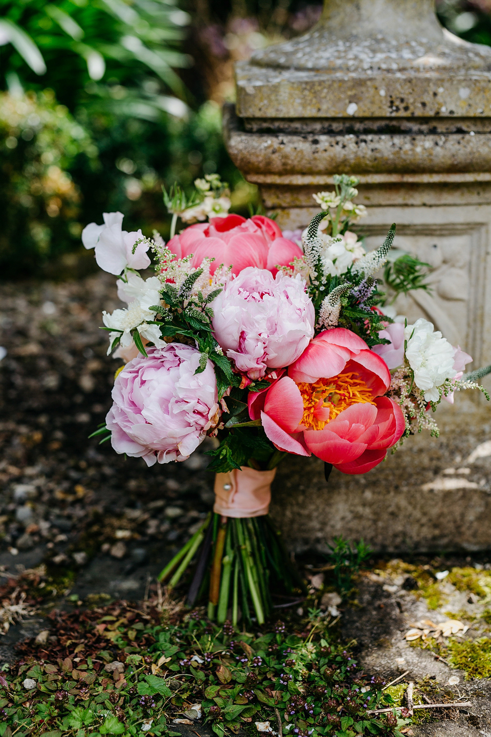 A Suzanne Neville gown and shades fo pink for a colourful wedding at Healey Barn, Northumberland. Photography by John Hope.