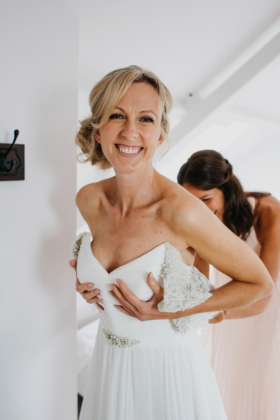 A Suzanne Neville gown and shades fo pink for a colourful wedding at Healey Barn, Northumberland. Photography by John Hope.